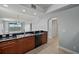 Open kitchen featuring stainless steel sink, black dishwasher and countertops, and cherry-toned cabinets at 17495 Boca Vista Rd # 6, Punta Gorda, FL 33955