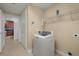 Laundry room with a white washing machine, wire shelving, and access to additional rooms at 17495 Boca Vista Rd # 6, Punta Gorda, FL 33955