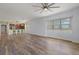 Bright living space featuring a modern ceiling fan, wood-look flooring, and an open concept design at 17495 Boca Vista Rd # 6, Punta Gorda, FL 33955
