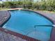 Inviting pool with a brick surround and steps for easy access at 17495 Boca Vista Rd # 6, Punta Gorda, FL 33955