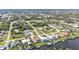 Wide aerial shot displays waterfront houses with boat docks in a well-maintained canal neighborhood at 18536 Alphonse Cir, Port Charlotte, FL 33948