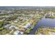 Picturesque aerial view highlighting homes with boat docks along a winding canal and a scenic lake at 18536 Alphonse Cir, Port Charlotte, FL 33948
