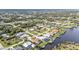 Expansive aerial view of a residential community with waterfront homes and private boat docks on canals at 18536 Alphonse Cir, Port Charlotte, FL 33948