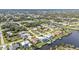 Serene aerial view showcases waterfront homes and docks in a lush, canal-lined residential community at 18536 Alphonse Cir, Port Charlotte, FL 33948