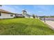 Sprawling lawn and a backyard waterfront setting with a canal and a private dock at 18536 Alphonse Cir, Port Charlotte, FL 33948