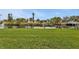 Expansive grassy backyard features a private dock with canal access, perfect for boating at 18536 Alphonse Cir, Port Charlotte, FL 33948