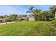 Lush backyard with a storage shed and a canal view, offering serene waterfront living at 18536 Alphonse Cir, Port Charlotte, FL 33948
