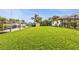 Expansive lawn leading to a private dock and canal, providing ample outdoor space at 18536 Alphonse Cir, Port Charlotte, FL 33948