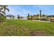 Spacious backyard with a waterfront view, featuring a dock for boating and outdoor activities at 18536 Alphonse Cir, Port Charlotte, FL 33948