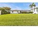 Large backyard with a screened-in pool and lush green lawn perfect for relaxing and entertaining at 18536 Alphonse Cir, Port Charlotte, FL 33948