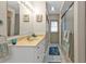 Cozy bathroom with tiled floors, single sink vanity, and a shower with glass doors at 18536 Alphonse Cir, Port Charlotte, FL 33948