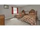 Guest bedroom with two twin beds, neutral walls, and a window with curtains at 18536 Alphonse Cir, Port Charlotte, FL 33948