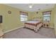 Comfortable bedroom with carpet, a ceiling fan, and two large windows providing plenty of natural light at 18536 Alphonse Cir, Port Charlotte, FL 33948