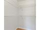 Spacious closet with white wire shelving on a white wall and brown carpeted floor at 18536 Alphonse Cir, Port Charlotte, FL 33948