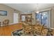 Well-lit dining area with wood floors, seating for six, and sliding glass doors to the outside at 18536 Alphonse Cir, Port Charlotte, FL 33948