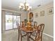 Cozy dining area with a wooden table and view to the lanai and pool through glass sliding doors at 18536 Alphonse Cir, Port Charlotte, FL 33948