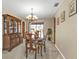 Warm and inviting dining room featuring a wooden table and upholstered chairs beneath an elegant chandelier at 18536 Alphonse Cir, Port Charlotte, FL 33948