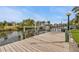 Exterior view of the home's private boat dock, with a covered lift, on a canal at 18536 Alphonse Cir, Port Charlotte, FL 33948