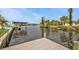 Waterfront view featuring a private dock with boat lift, offering direct access to scenic waterways at 18536 Alphonse Cir, Port Charlotte, FL 33948