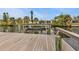 A wooden dock along the canal has a boat lift, promising scenic waterfront adventures at 18536 Alphonse Cir, Port Charlotte, FL 33948