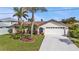 A charming home with a well-kept lawn and two-car garage, perfect for Gathering living at 18536 Alphonse Cir, Port Charlotte, FL 33948