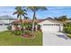 A beautiful home with a manicured front yard and a two-car garage, showcasing curb appeal at 18536 Alphonse Cir, Port Charlotte, FL 33948