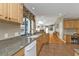 Modern kitchen with stainless steel sink, granite countertops, and a view of the living room and patio at 18536 Alphonse Cir, Port Charlotte, FL 33948