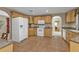 Spacious kitchen with wood cabinets, tile flooring and white appliances at 18536 Alphonse Cir, Port Charlotte, FL 33948