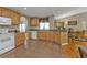 Modern kitchen with stainless steel appliances, granite countertops, and hardwood cabinets in the distance at 18536 Alphonse Cir, Port Charlotte, FL 33948
