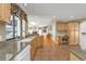 Modern kitchen with stainless steel sink, granite countertops, and a view of the living room and patio at 18536 Alphonse Cir, Port Charlotte, FL 33948