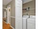 Convenient laundry room featuring a washer, dryer, and storage shelves at 18536 Alphonse Cir, Port Charlotte, FL 33948