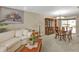 Living room features a comfortable sofa, dark wood furniture, and neutral paint at 18536 Alphonse Cir, Port Charlotte, FL 33948