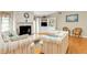 Inviting living room with a stone fireplace, built-in shelving, and comfortable striped sofas at 18536 Alphonse Cir, Port Charlotte, FL 33948