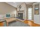 Living room featuring a stone fireplace, built-in shelving, and lots of natural light at 18536 Alphonse Cir, Port Charlotte, FL 33948
