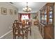 Cozy formal living room, decorated with floral drapes and a beautiful chandelier with hardwood furniture and decor at 18536 Alphonse Cir, Port Charlotte, FL 33948