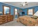 Charming main bedroom with blue walls, ceiling fan, and a window with natural light at 18536 Alphonse Cir, Port Charlotte, FL 33948