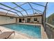 A screened-in pool offers a refreshing escape with a charming deck and a tranquil ambiance at 18536 Alphonse Cir, Port Charlotte, FL 33948