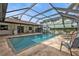 Inviting screened-in pool area with tile surround and comfortable lounge seating at 18536 Alphonse Cir, Port Charlotte, FL 33948