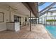Outdoor pool with a bar area, ceiling fans, seating and a screened in enclosure at 18536 Alphonse Cir, Port Charlotte, FL 33948