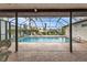 Outdoor pool with chairs, privacy landscaping, and a screened in enclosure at 18536 Alphonse Cir, Port Charlotte, FL 33948