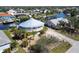 Aerial view of unique home design surrounded by palm trees and a circular drive at 19170 Aviation Ct, Port Charlotte, FL 33948