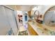 Bright bathroom featuring dual sinks, walk-in shower, vanity and a laundry area at 19170 Aviation Ct, Port Charlotte, FL 33948
