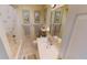 Clean bathroom featuring a shower and vanity with ample lighting at 19170 Aviation Ct, Port Charlotte, FL 33948