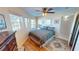 Comfortable bedroom with hardwood floors, large windows and ceiling fan at 19170 Aviation Ct, Port Charlotte, FL 33948