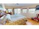 Comfortable bedroom featuring a king-sized bed, ceiling fan, and access to a private balcony at 19170 Aviation Ct, Port Charlotte, FL 33948