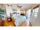 Comfortable bedroom with natural light, ceiling fan, hardwood floors, and sliding door access to a private deck at 19170 Aviation Ct, Port Charlotte, FL 33948