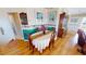 Cozy dining area featuring wood floors, a classic china cabinet, and seating for four at 19170 Aviation Ct, Port Charlotte, FL 33948