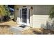 Inviting front entrance with a decorative door, exterior lights, and beige siding at 19170 Aviation Ct, Port Charlotte, FL 33948