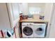 Bright laundry room with a side-by-side washer and dryer and functional countertop space at 19170 Aviation Ct, Port Charlotte, FL 33948