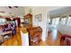 Inviting living room featuring an antique rolltop desk, hardwood floors, and an open floor plan into the kitchen at 19170 Aviation Ct, Port Charlotte, FL 33948